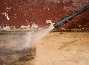 Power washing a concrete driveway